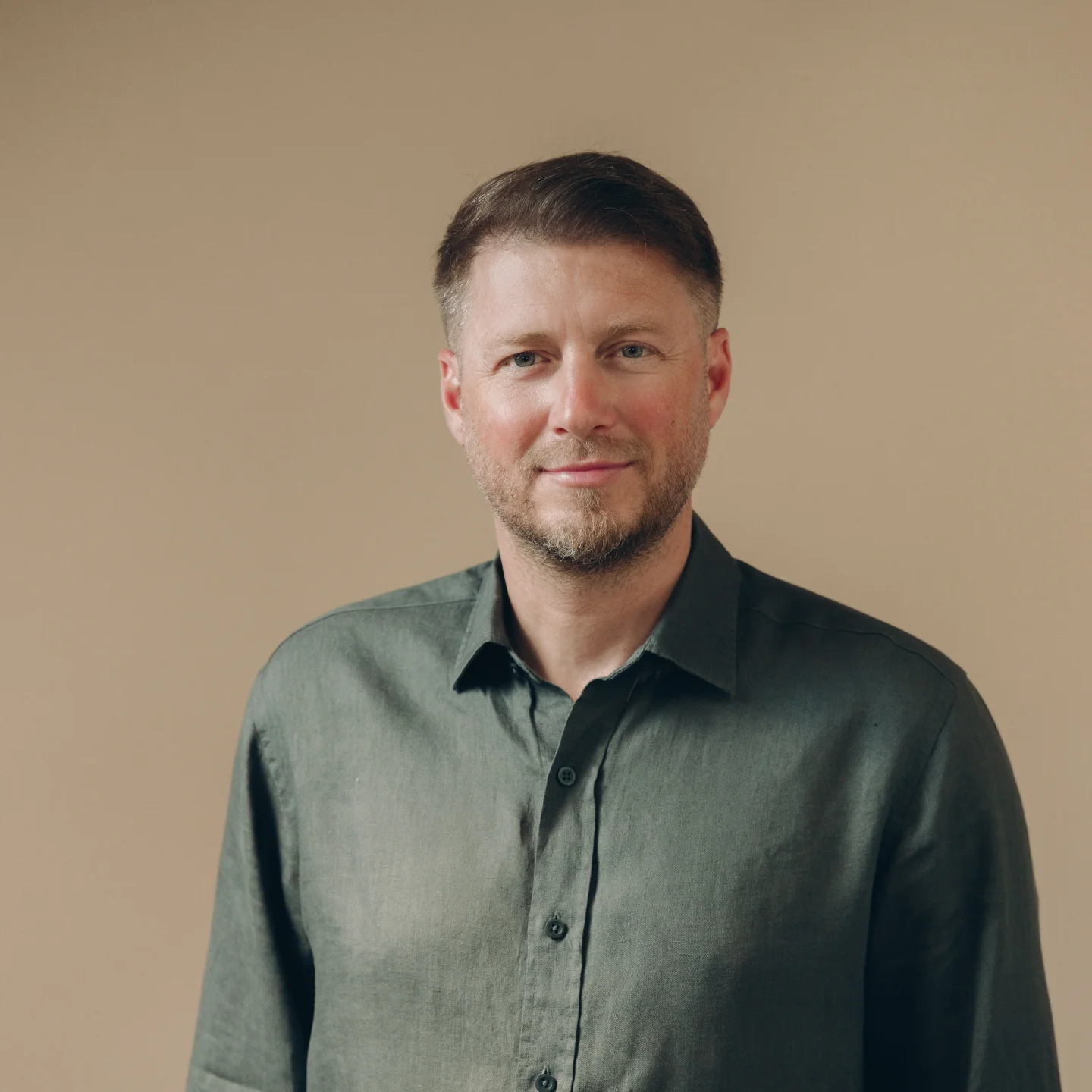 Team member portrait, dark green shirt