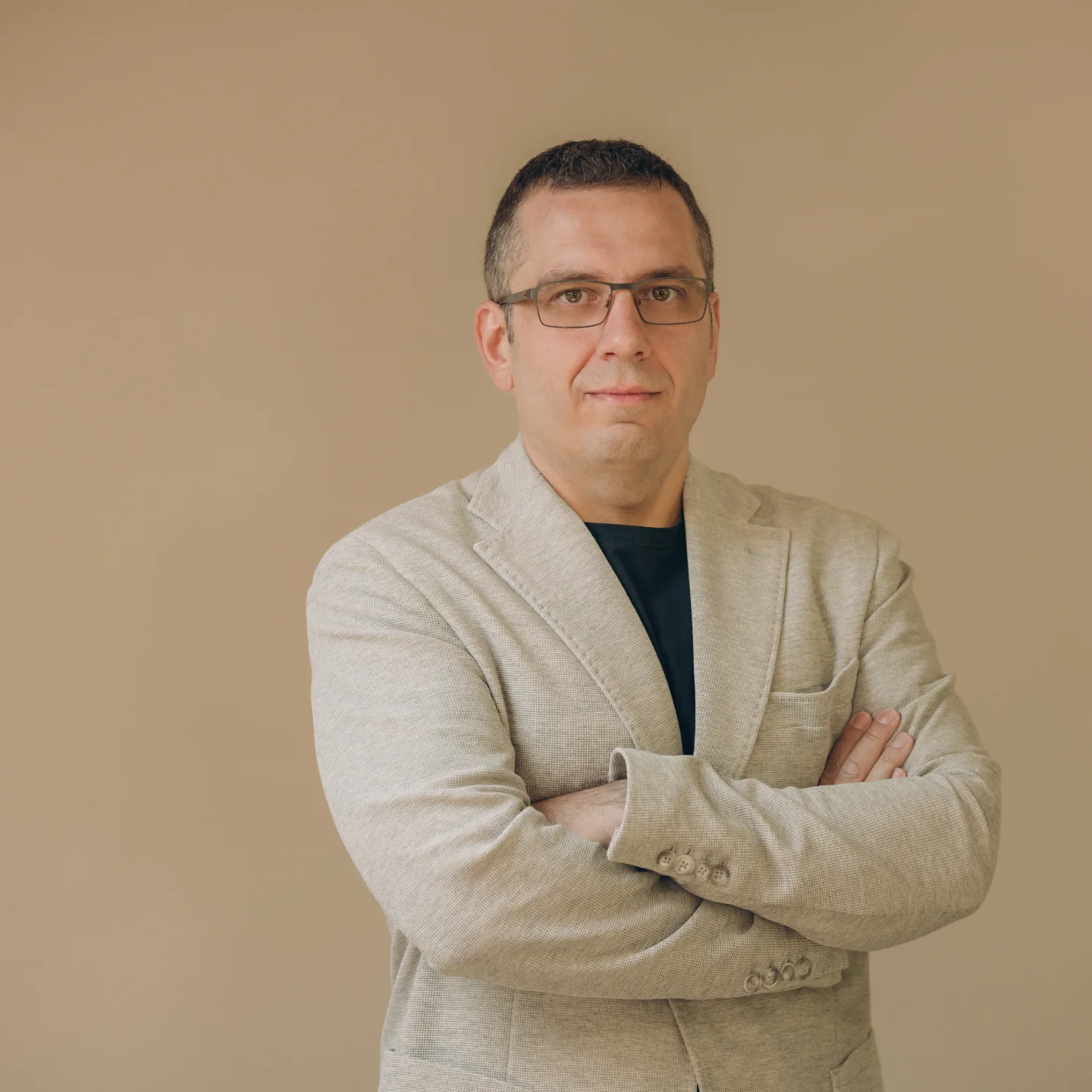 Team member portrait, glasses and light blazer