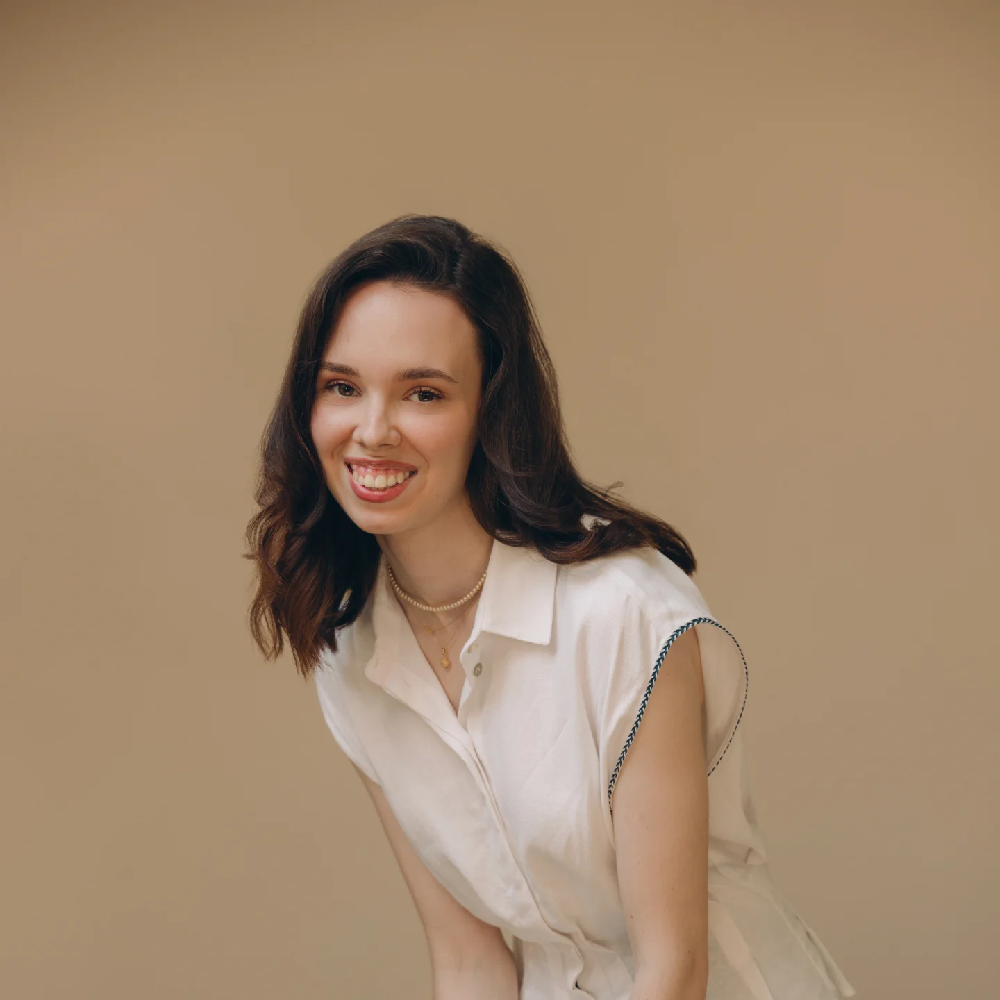 Team member portrait, seated and smiling