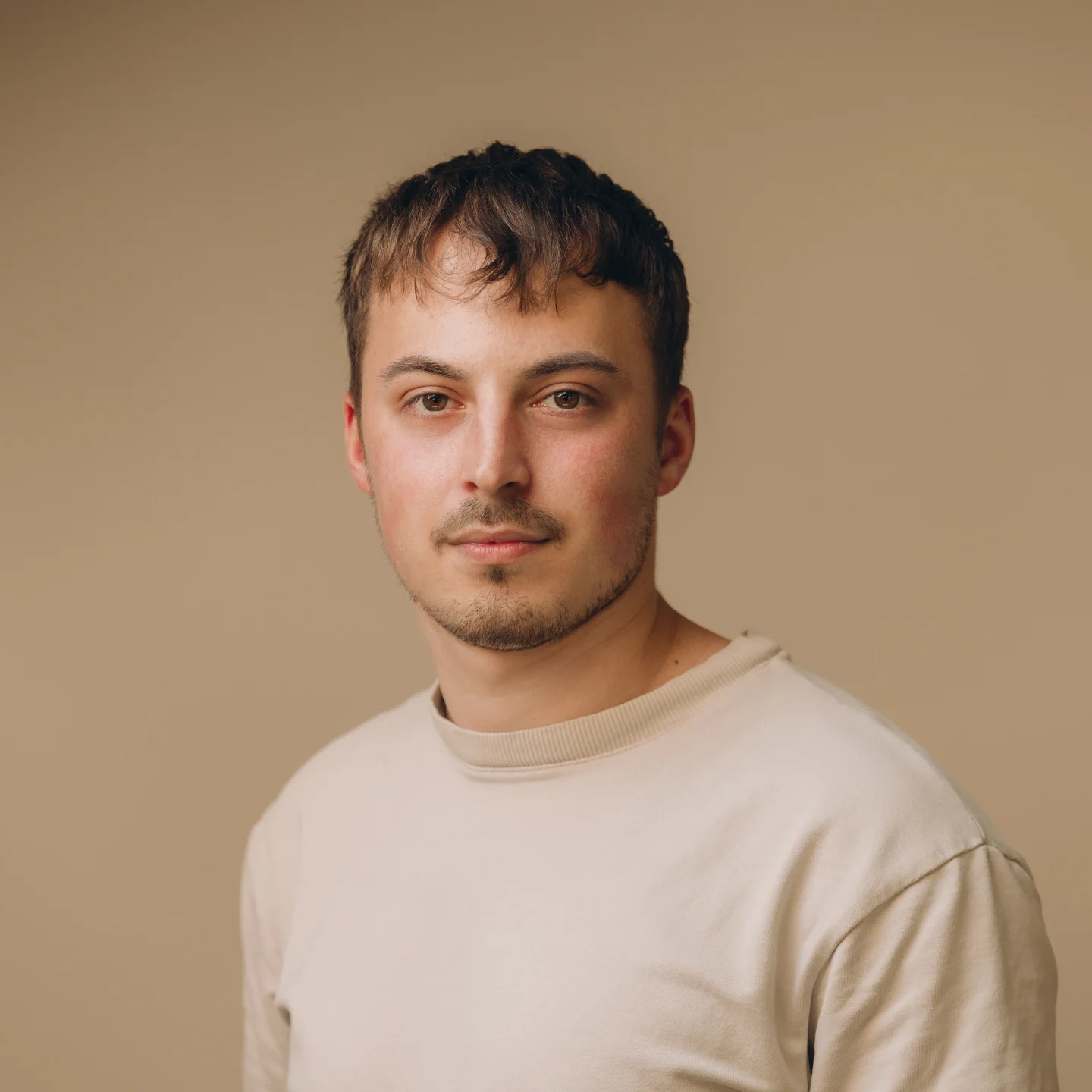 Team member portrait, beige tee